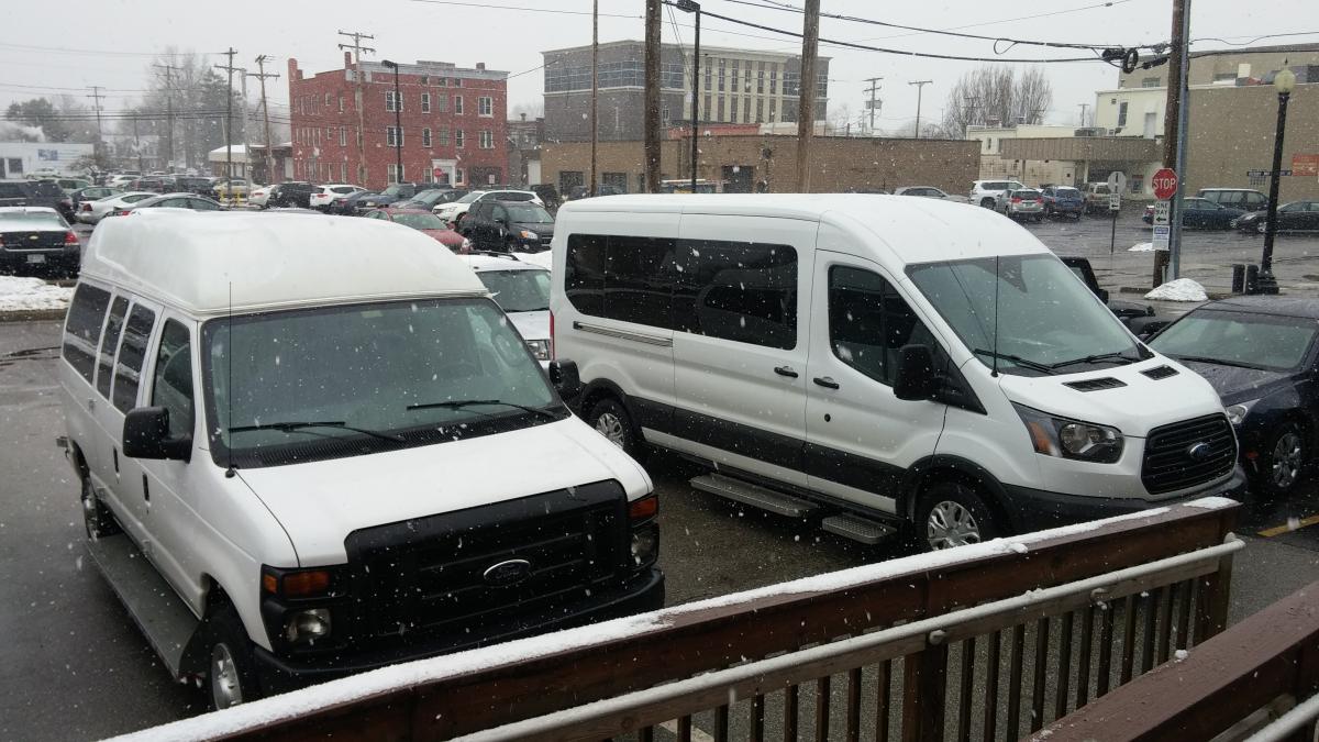 Picture of two Independence vans used for providing transportation.
